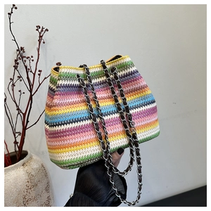 Detail of colorful rainbow woven shoulder bag with leather chain strap in bohemian style