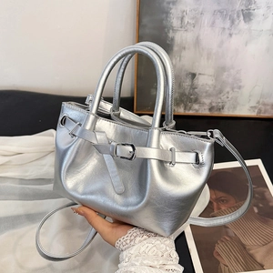 Metallic silver drawstring handbag with mirror finish and adjustable crossbody strap
