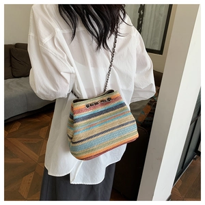 Detailed view of the woven texture and colorful stripes on the chain shoulder bag