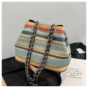 Detail view of colorful bohemian woven shoulder bag with silver metal chain straps