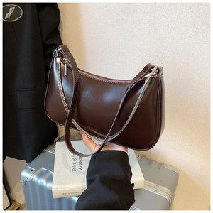 Detail of dark brown faux leather hobo bag with silver chain and NO FILTER embossing