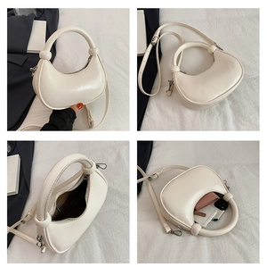Detail view of crescent crossbody bag capacity showing interior space and zipper
