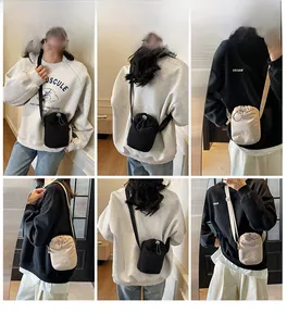 Model wearing mini drawstring canvas crossbody bag in black and beige variants