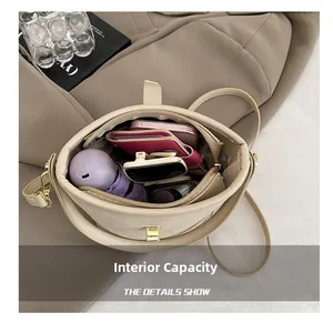 Top view showing the spacious interior of this beige bucket bag with daily essentials