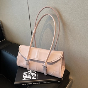 Minimalist light pink leather shoulder bag with decorative straps and silver buckles