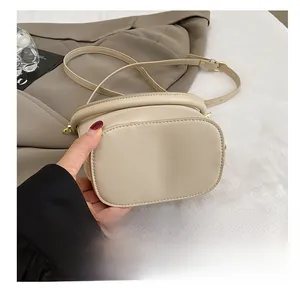 Close-up of the reinforced wear-resistant base and smooth faux leather of the bucket bag