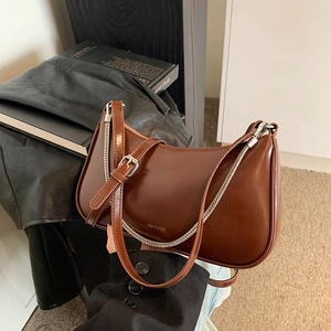 Retro brown hobo shoulder bag for women featuring a sleek finish and silver chain detail