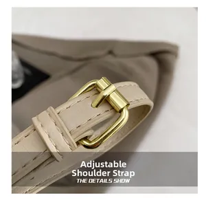 Detail of adjustable faux leather shoulder strap with premium gold metal buckle