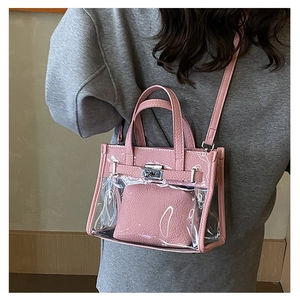Detailed view of pink transparent jelly bag with matching inner pouch and lock charm