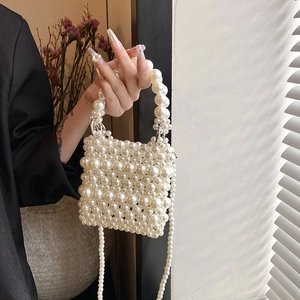 Elegant handmade pearl woven crossbody bag with top handle and shoulder strap in cream white