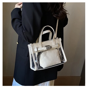Detailed side view of a transparent PVC Kelly style bag with white leather inner pouch