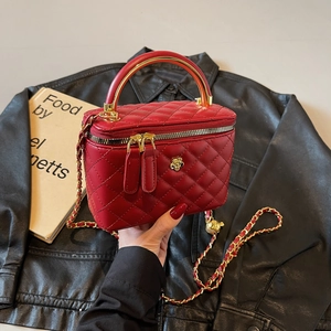 Red quilted leather vanity bucket bag with gold chain strap and metal handle