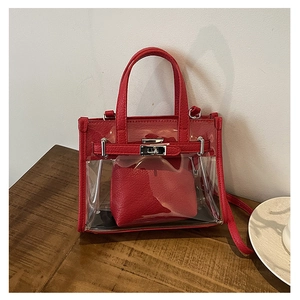 Detail of red lychee texture leather and transparent PVC stitching on the Kelly style bag