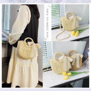 Detail of woven straw bag featuring white lace bow and delicate wicker texture details