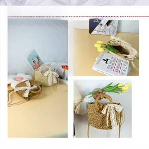Detail of woven straw bag with white lace bow and drawstring closure in two colors