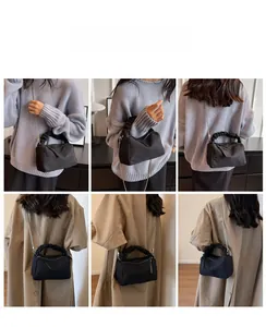 Chic black nylon dumpling bag shown with casual knitwear and a classic khaki trench coat
