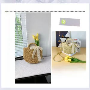Detail view of woven straw bag with a white lace bow and round ring handle