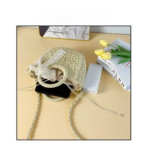 Straw bag size reference showing interior capacity for a mobile phone and power bank