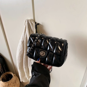 Elegant black quilted chain shoulder bag with silver rotary buckle on a clean backdrop