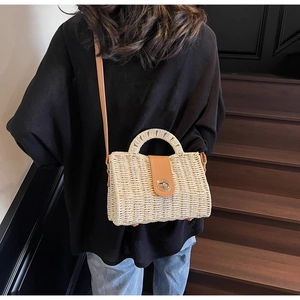 Handmade woven straw tote bag with brown PU leather trim and metal twist lock closure