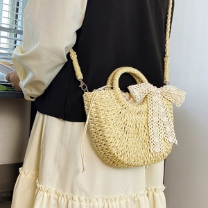 Chic beige woven straw crescent bag with white lace bow and drawstring closure for women