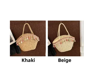 Detail of khaki and beige woven straw bags with colorful bohemian tassels and embroidery