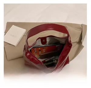 Top view of wine red glossy tote bag showing large capacity for tablet and cosmetics