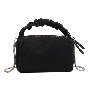 Minimalist black nylon dumpling bag with pleated handle and silver metal chain strap