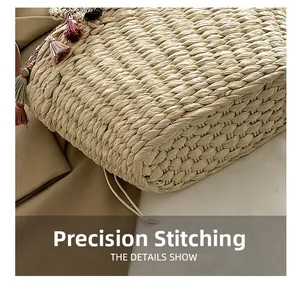 Macro detail of the dense straw weaving and bohemian tassels on the beach tote bag