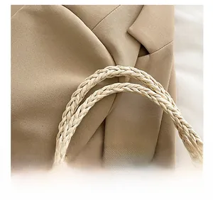 Close-up of khaki woven handle and textured fabric on the large capacity beach tote