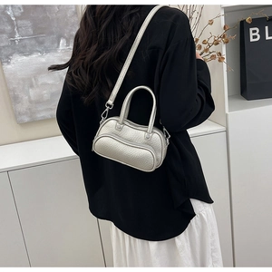 Detail of silver pebble grain mini bowling bag with top handles and adjustable strap