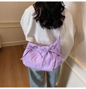 Detail of lavender canvas crossbody bag with decorative ruffles and sweet bow knots