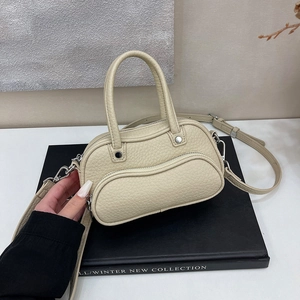 Detail of creamy white litchi grain leather mini boston bag with curved zipper pocket