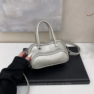 Detail of silver bucket bag with lychee texture and adjustable shoulder strap