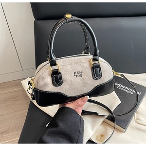 Contrast stitching bowling handbag in beige canvas and black leather with shoulder strap