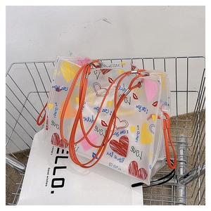 Detail of transparent PVC tote bag with colorful graffiti and orange rope handles