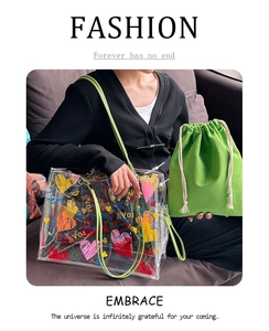 Transparent PVC tote bag with colorful heart patterns and a green canvas inner pouch