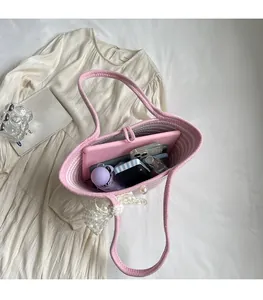 Top view of pink woven beach bag interior showing large capacity for daily essentials
