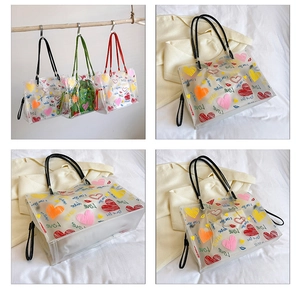 Detail of transparent PVC tote bag featuring colorful love prints and black leather handles