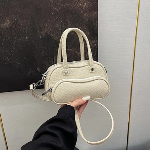 Minimalist beige pebble leather handbag with wave zipper pocket and detachable strap