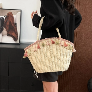 Bohemian straw tote bag with colorful tassels and braided handles for summer beach vacations