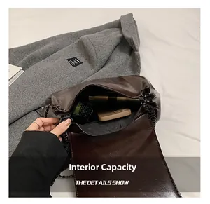 Interior view of deep brown chain bag showing large capacity for phone and power bank