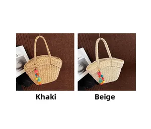Detail of woven straw bags in khaki and beige colors with colorful pompom tassel charms