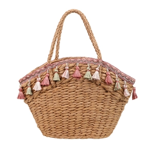 Straw tote bag with pink lace and colorful tassels for summer beach vacation
