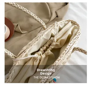 Detail of the woven straw bag featuring a drawstring closure and linen lining interior