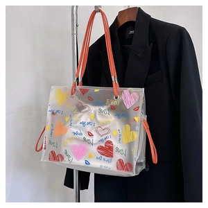 Detail of transparent PVC tote with colorful heart graffiti and orange handles