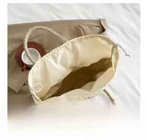 Internal view of handwoven basket bag showing spacious interior with drawstring lining