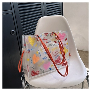 Detail of transparent PVC tote bag with colorful heart patterns and Love print