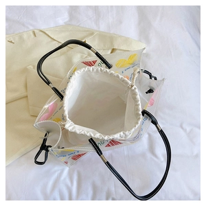 Detailed view of transparent PVC tote bag with colorful heart patterns and inner pouch