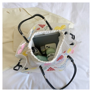 Detail of transparent PVC tote bag with colorful heart prints and canvas inner pouch
